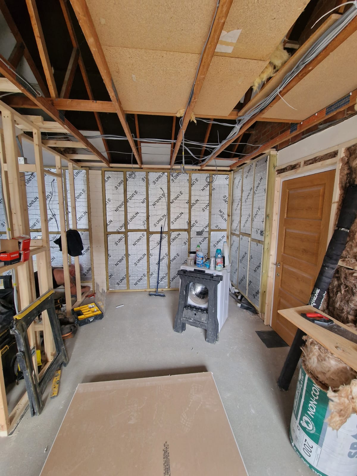 Double garage conversion in progress — internal timber framing, insulation and first-fix cables in Chelmsford